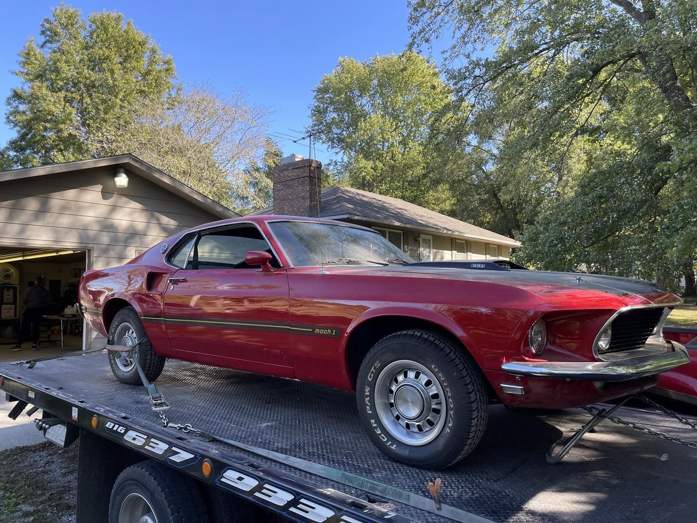 Classic Mustang Mach 1 strapped on the flatbed on a sunny day